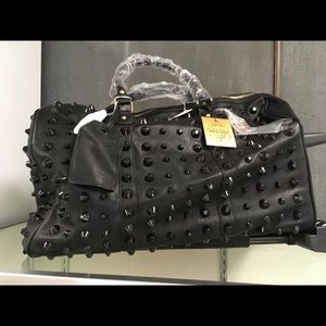 Traci Lynn black rolling duffle. NWT